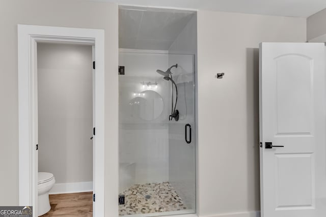 10005 Lakeview Pkwy, Villa Rica, GA 30180 - bathroom with a shower stall, toilet, baseboards, and wood finished floors