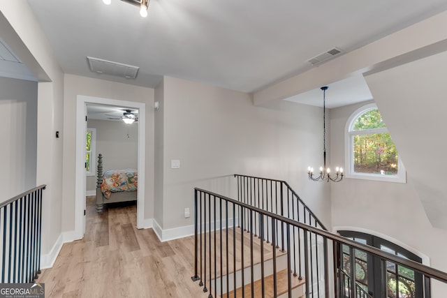 10005 Lakeview Pkwy, Villa Rica, GA 30180 - corridor with an upstairs landing, light wood-style floors, baseboards, and a chandelier