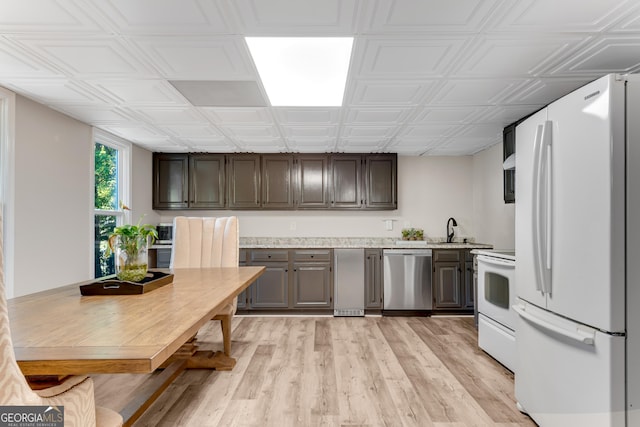 10005 Lakeview Pkwy, Villa Rica, GA 30180 - kitchen with white appliances, light countertops, light wood-style floors, an ornate ceiling, and a sink