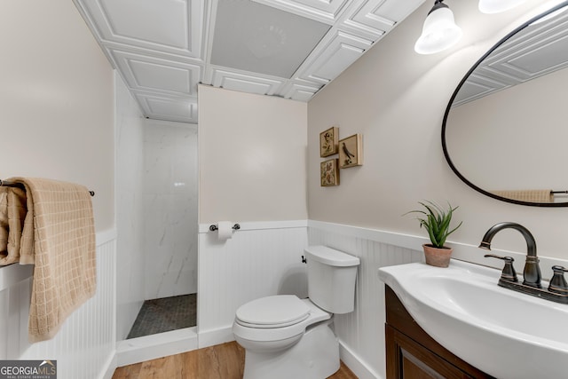 10005 Lakeview Pkwy, Villa Rica, GA 30180 - full bathroom featuring vanity, a walk in shower, toilet, wainscoting, and wood finished floors