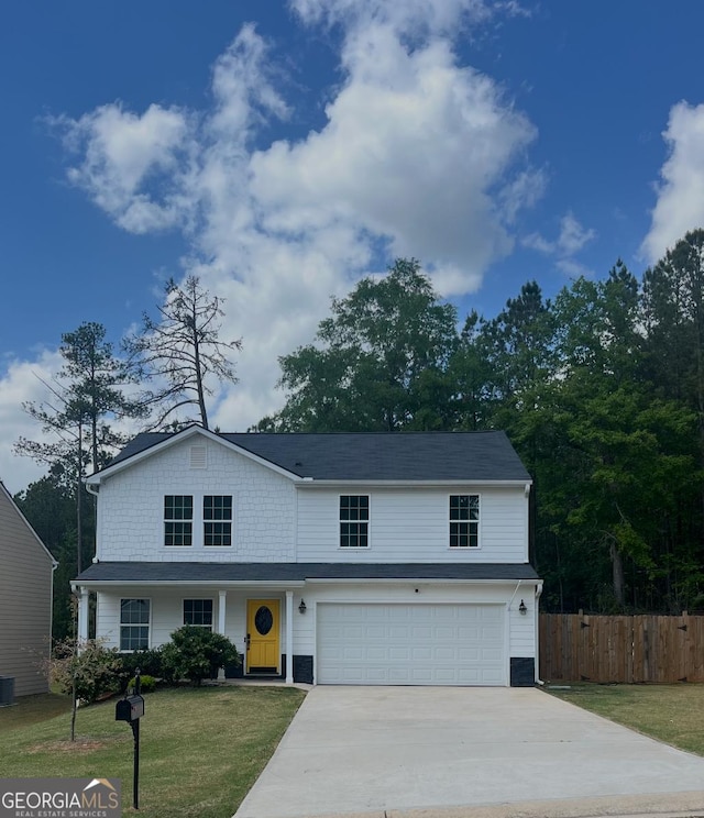 traditional-style home featuring a garage, concrete driveway, and central AC