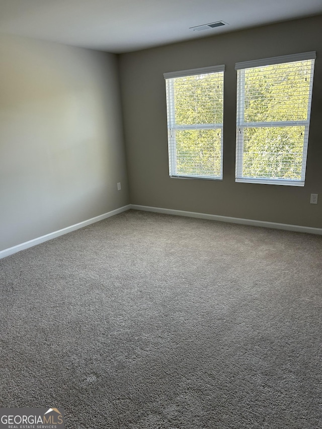 unfurnished room featuring baseboards and carpet floors