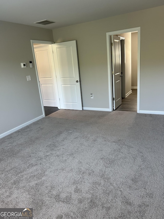 unfurnished bedroom with carpet and baseboards