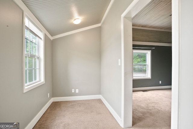 carpeted spare room featuring baseboards