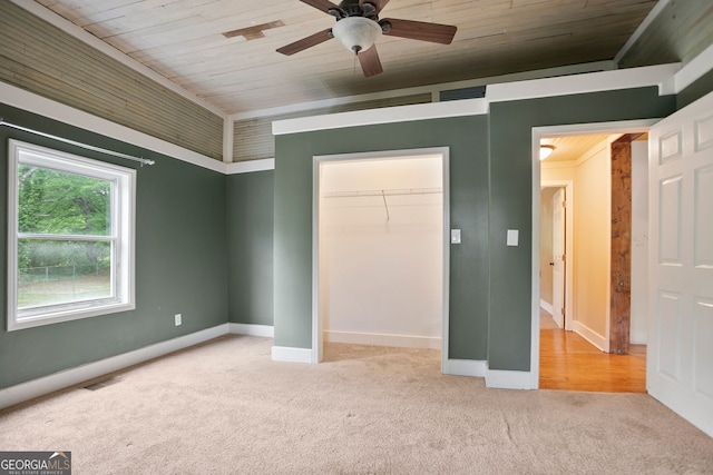 unfurnished bedroom with carpet, visible vents, wooden ceiling, and a closet