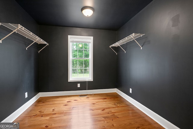 walk in closet featuring wood finished floors