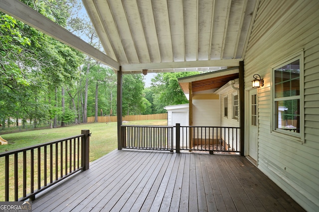 deck with a lawn, a garage, and a fenced backyard