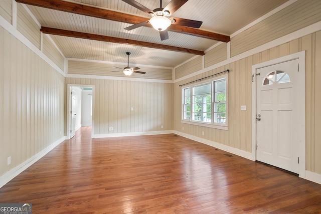 entrance foyer featuring wood walls, ceiling fan, hardwood / wood-style floors, and beamed ceiling