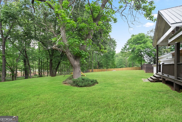 view of yard with fence and a deck