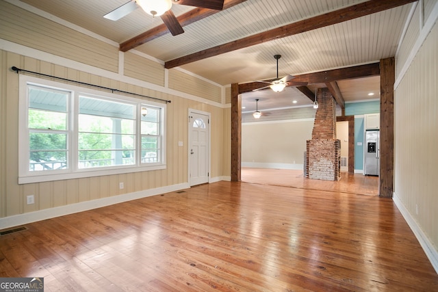 unfurnished living room featuring hardwood / wood-style floors, decorative columns, beamed ceiling, visible vents, and a ceiling fan