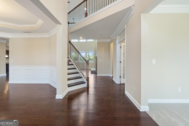 entryway featuring stairway, crown molding, wood finished floors, and visible vents