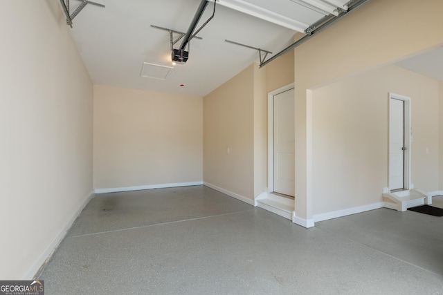 garage with baseboards and a garage door opener