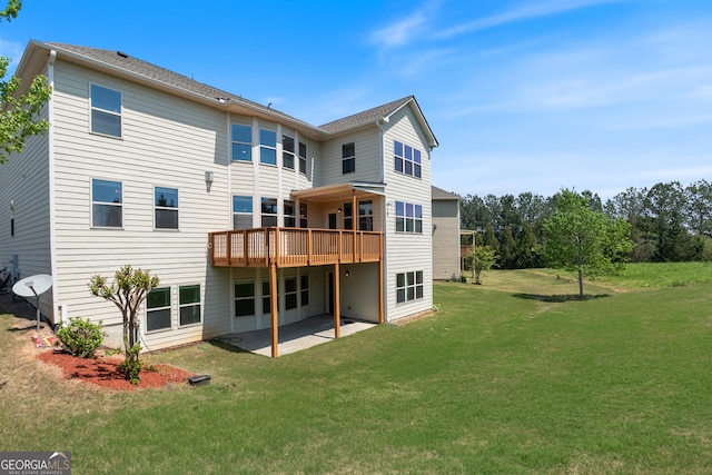 rear view of property with a lawn, a deck, and a patio