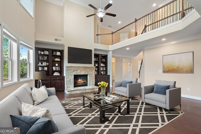 living room featuring a high ceiling, crown molding, and wood finished floors