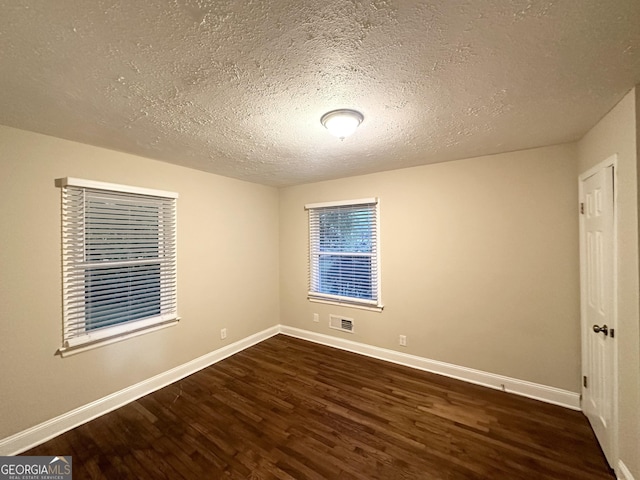 2965 Meadowview Dr SE, Atlanta, GA 30316 - empty room with a textured ceiling, wood finished floors, visible vents, and baseboards