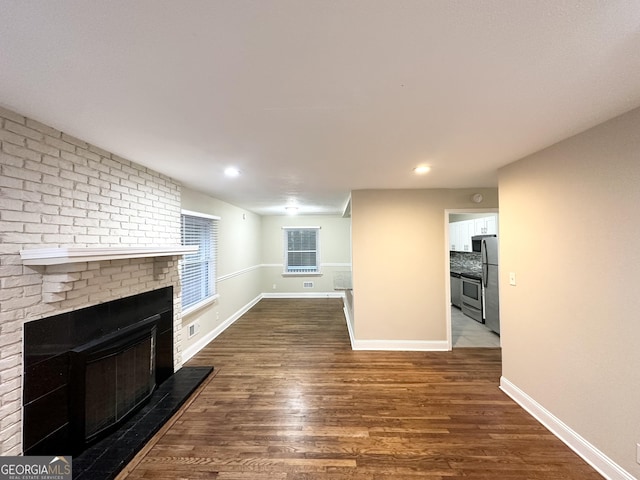 2965 Meadowview Dr SE, Atlanta, GA 30316 - unfurnished living room featuring dark wood-type flooring, a fireplace, and baseboards