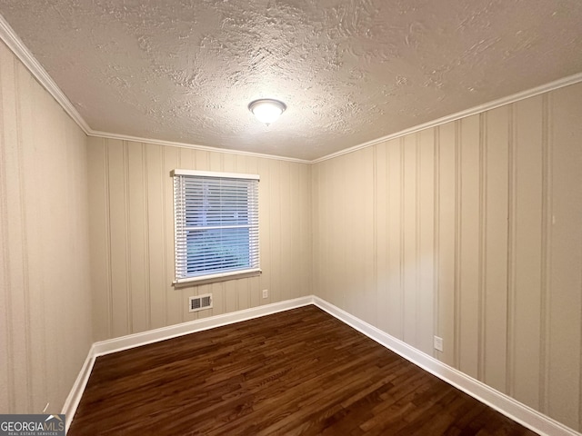 2965 Meadowview Dr SE, Atlanta, GA 30316 - unfurnished room with a textured ceiling, visible vents, crown molding, and dark wood-style flooring