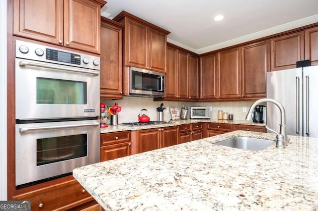 455 Cooper Woods Ct SE, Smyrna, GA 30082 - kitchen featuring stainless steel appliances, a sink, light stone countertops, recessed lighting, and backsplash
