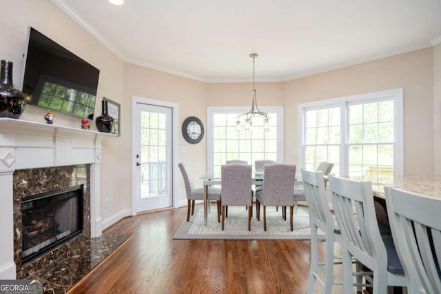 455 Cooper Woods Ct SE, Smyrna, GA 30082 - dining space with wood finished floors, a high end fireplace, a chandelier, ornamental molding, and baseboards
