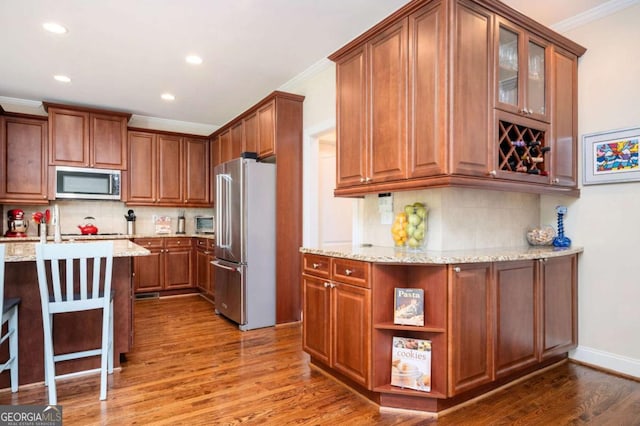 455 Cooper Woods Ct SE, Smyrna, GA 30082 - kitchen with appliances with stainless steel finishes, crown molding, recessed lighting, wood finished floors, and tasteful backsplash