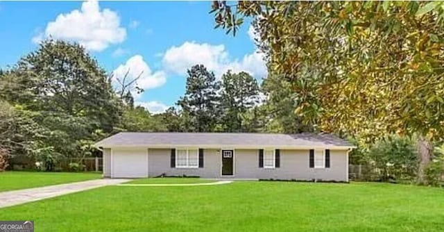ranch-style home with a garage, a front lawn, and concrete driveway