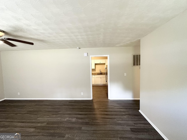 spare room featuring baseboards, a ceiling fan, a sink, and visible vents