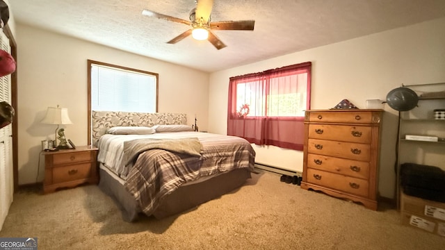 carpeted bedroom with a ceiling fan and a textured ceiling