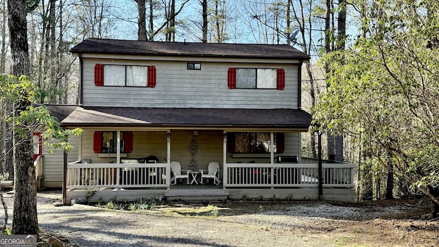 view of front of home with a shingled roof and covered porch
