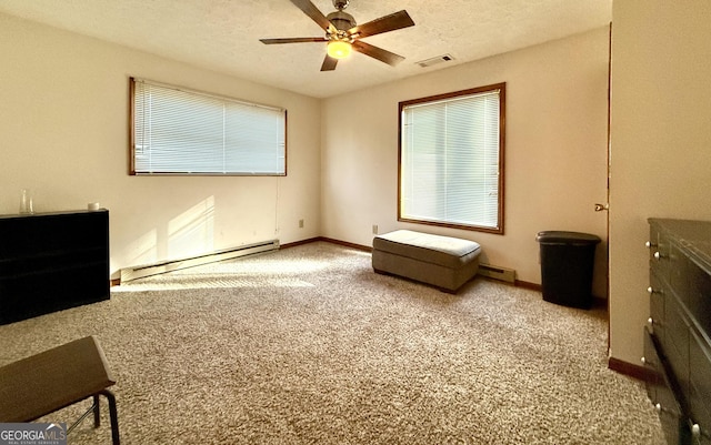carpeted bedroom featuring visible vents, a ceiling fan, baseboards, a baseboard heating unit, and a baseboard radiator