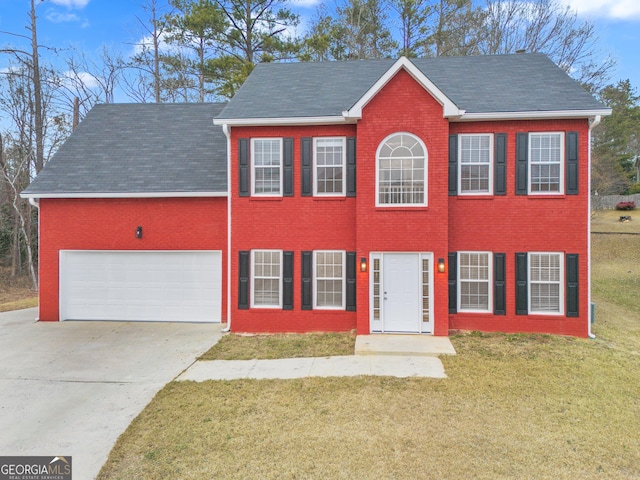 colonial home with roof with shingles, concrete driveway, brick siding, a front yard, and a garage