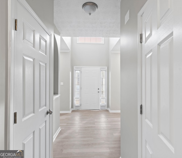 entrance foyer featuring light wood-style flooring and baseboards