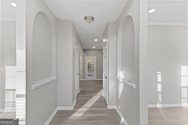 corridor featuring recessed lighting, wood finished floors, and baseboards