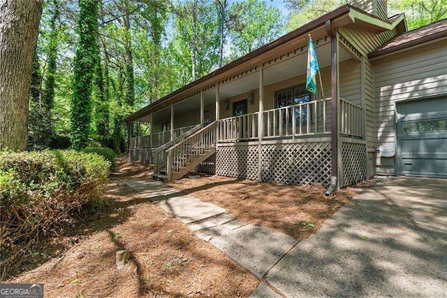 255 White Pines Dr, Alpharetta, GA 30004 - back of property featuring driveway, a porch, stairs, and a garage