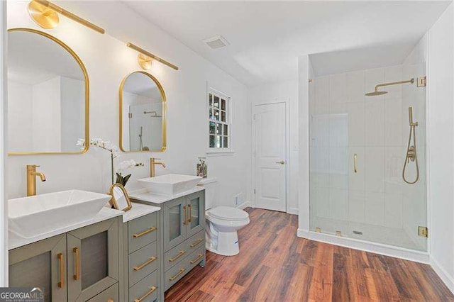 255 White Pines Dr, Alpharetta, GA 30004 - bathroom with wood finished floors, a sink, a shower stall, and double vanity