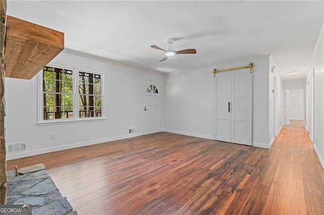 255 White Pines Dr, Alpharetta, GA 30004 - unfurnished living room with wood finished floors, visible vents, ornamental molding, baseboards, and ceiling fan