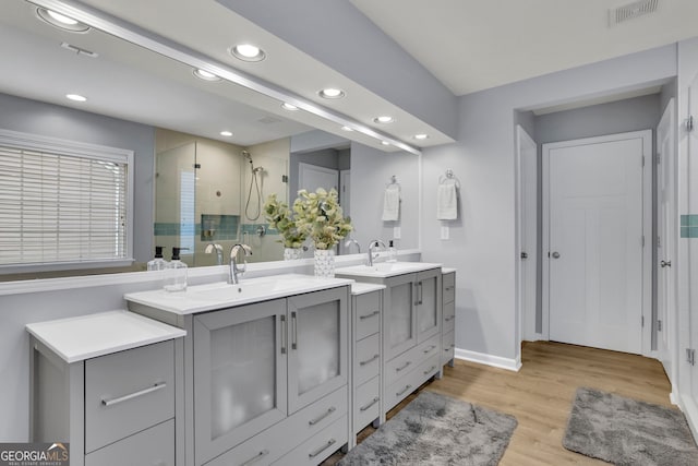 full bathroom with baseboards, visible vents, recessed lighting, wood finished floors, and a shower stall