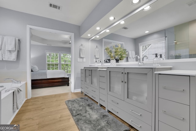 bathroom with recessed lighting, visible vents, and connected bathroom