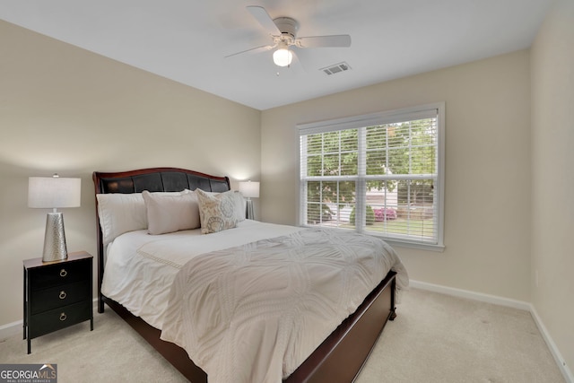 carpeted bedroom with baseboards, visible vents, and ceiling fan