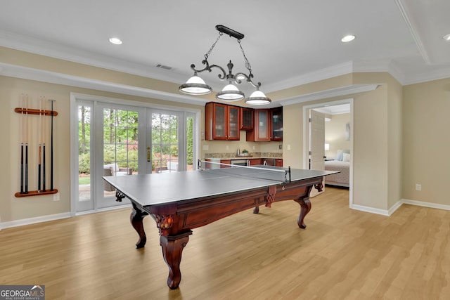 game room with french doors, light wood-style floors, and ornamental molding