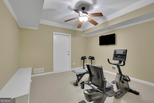 exercise room featuring baseboards, visible vents, carpet, a ceiling fan, and crown molding