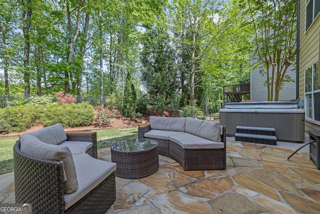 view of patio featuring an outdoor hangout area, a hot tub, and a fenced backyard