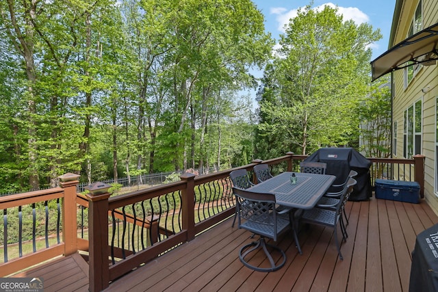 wooden terrace with fence and outdoor dining space