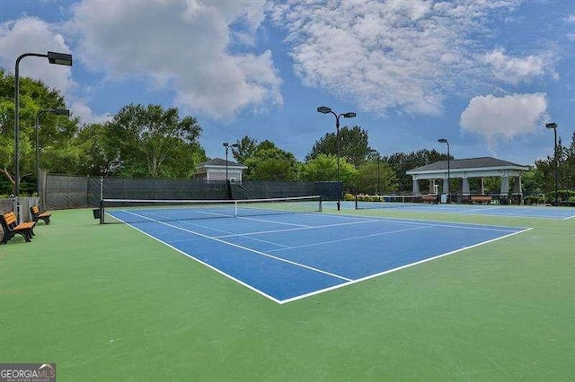 view of sport court featuring a gazebo and fence