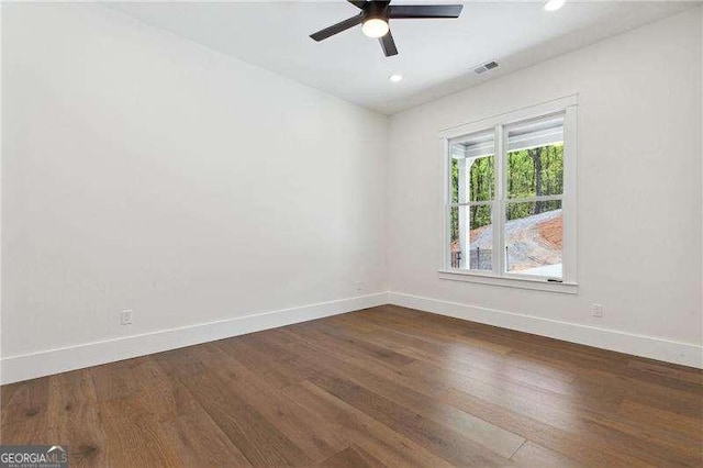 empty room featuring recessed lighting, visible vents, a ceiling fan, dark wood-type flooring, and baseboards