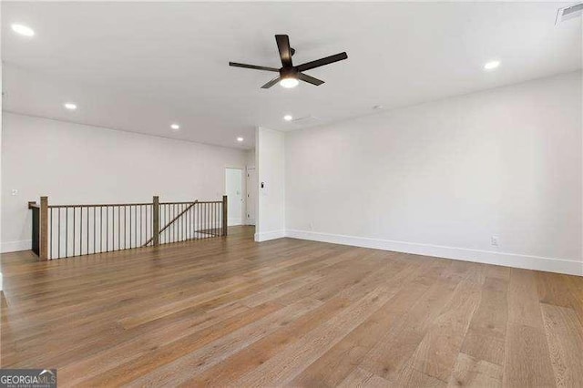 spare room featuring ceiling fan, baseboards, wood finished floors, and recessed lighting