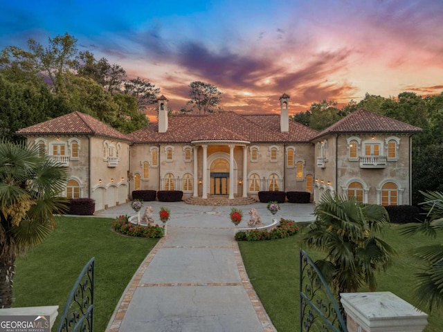 720 Heards Ferry Rd, Atlanta, GA 30328 - view of front of house featuring a tiled roof, a chimney, a front yard, and curved driveway