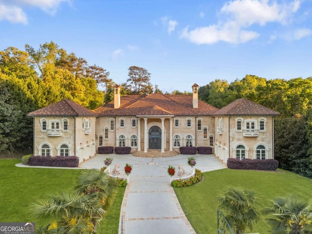 720 Heards Ferry Rd, Atlanta, GA 30328 - mediterranean / spanish house with a front lawn, driveway, and a chimney