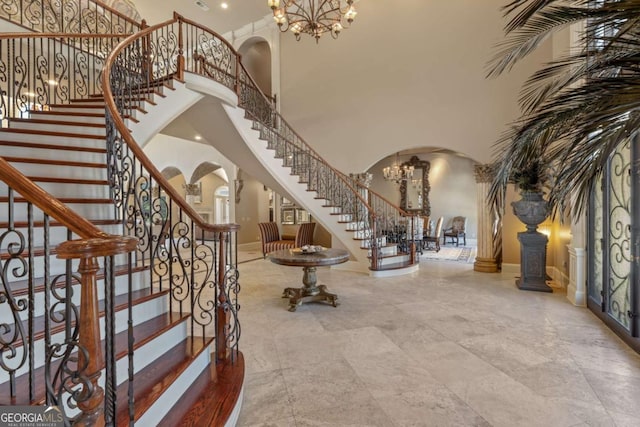 720 Heards Ferry Rd, Atlanta, GA 30328 - entrance foyer featuring arched walkways, a chandelier, a high ceiling, and stairs