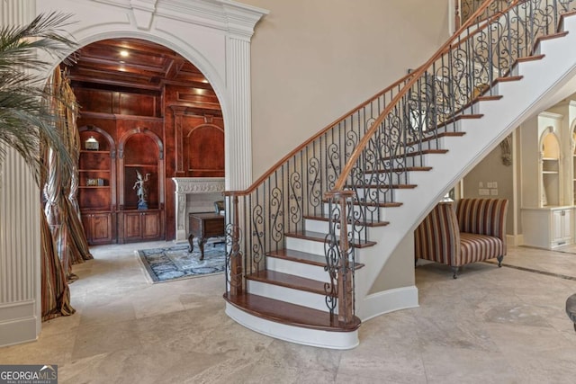 720 Heards Ferry Rd, Atlanta, GA 30328 - staircase featuring a high ceiling, a fireplace, marble finish floor, and built in features