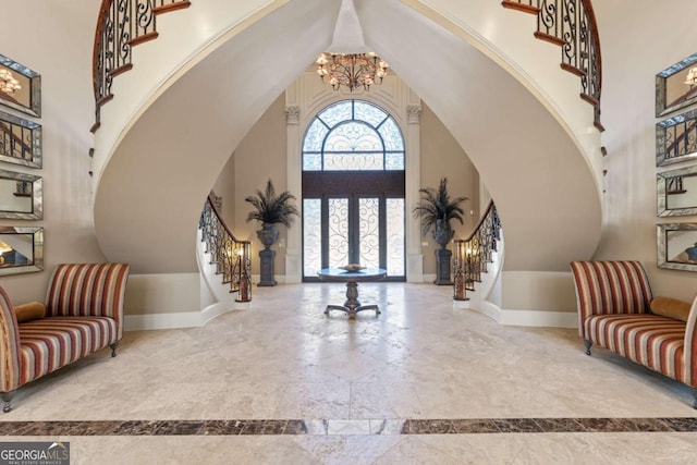 720 Heards Ferry Rd, Atlanta, GA 30328 - foyer entrance with stairway, baseboards, a chandelier, and high vaulted ceiling